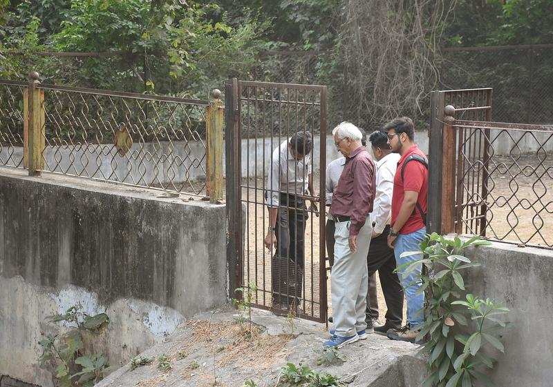 Zoo officials inspect the cage in which the dogs might have entered