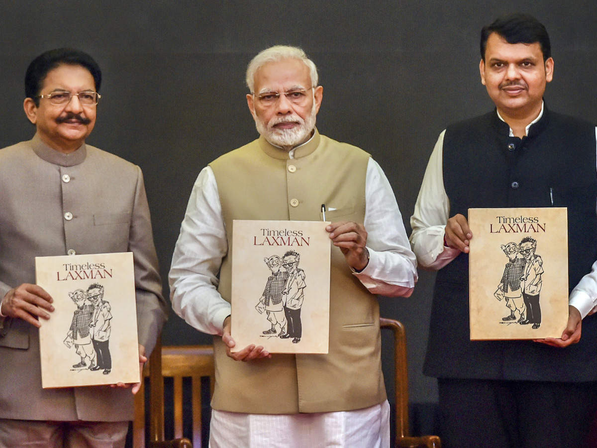 PM Narendra Modi (C) flanked by Maharashtra Governor C Vidyasagar Rao (L) and Maharashtra CM Devendra Fadnavis (R) during the book launch of 'Timeless Laxman', in Mumbai. (PTI photo)