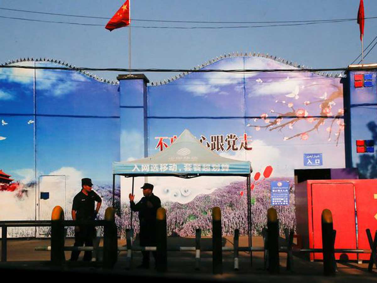 Security guards stand at the gates of what is officially known as a vocational skills education centre in Huocheng County in Xinjiang. (Reuters)