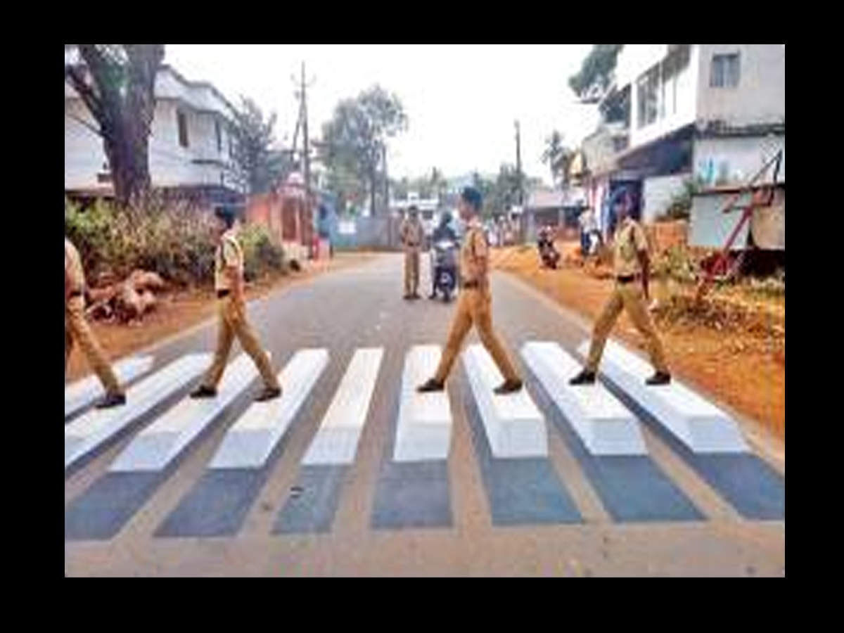 Student police cadets cross the 3D zebra line at Kannavam. 