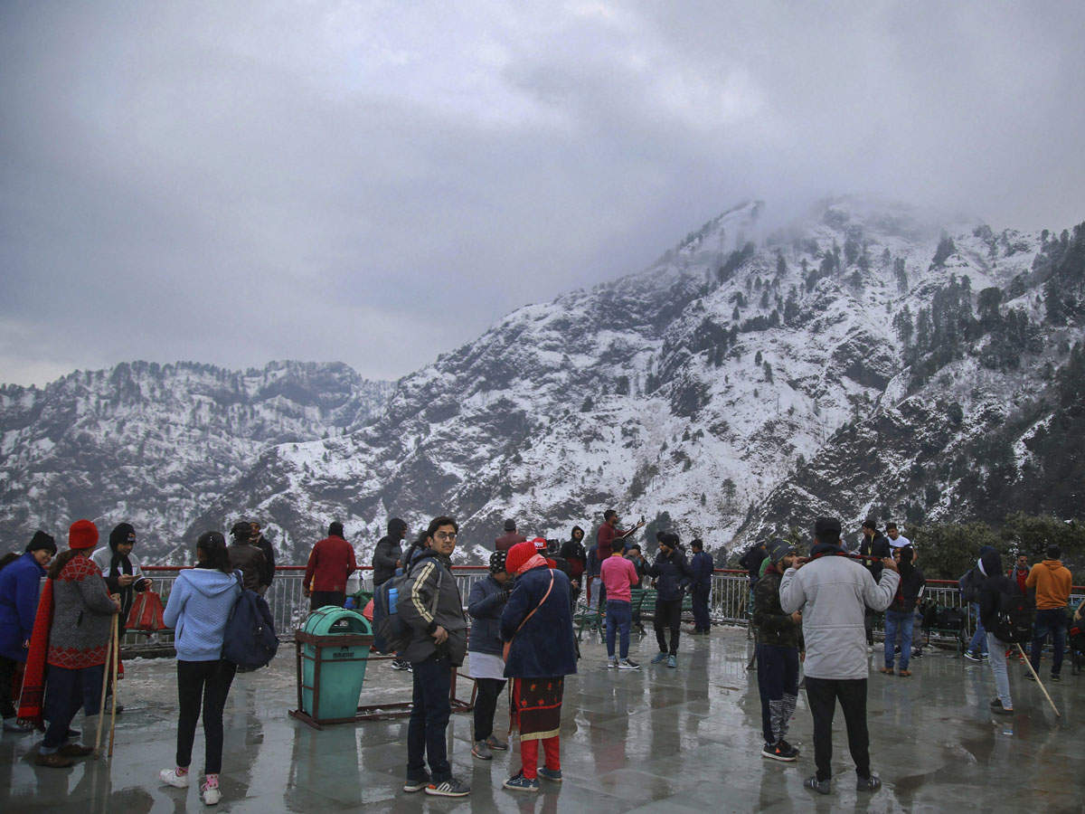 Pilgrims enjoy a view of snow-capped mountains as seen from the Bhairo Temple at Katra Vaishno Devi, in Jammu, on Jan. 06, 2019. (PTI photo)