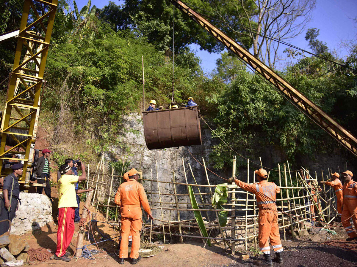 Navy divers are being lifted with a pulley during rescue operations to help 15 miners trapped by flooding in an illegal coal mine in Ksan village in Meghalaya's East Jaintia Hills district. (AFP photo)