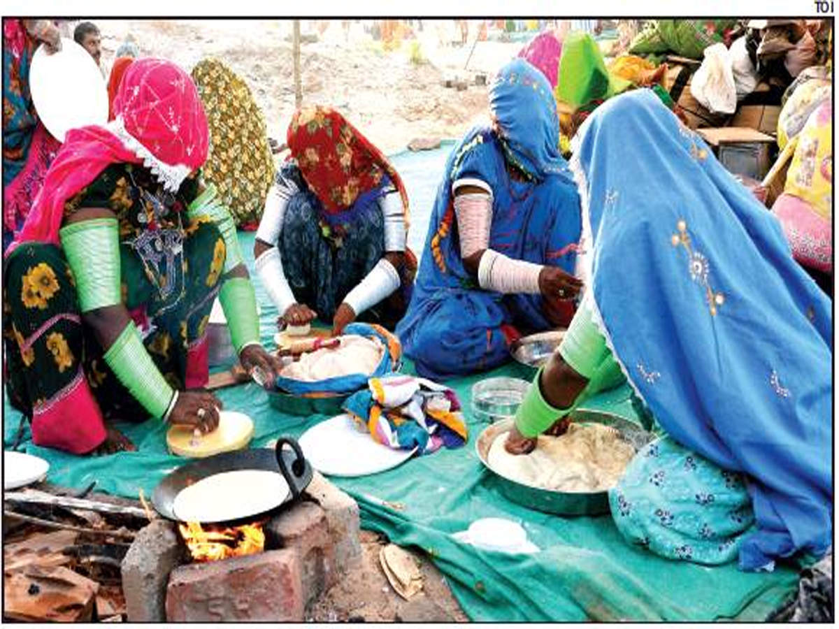 File photograph of Pakistani Hindus preparing rotis at an open place in Jodhpur