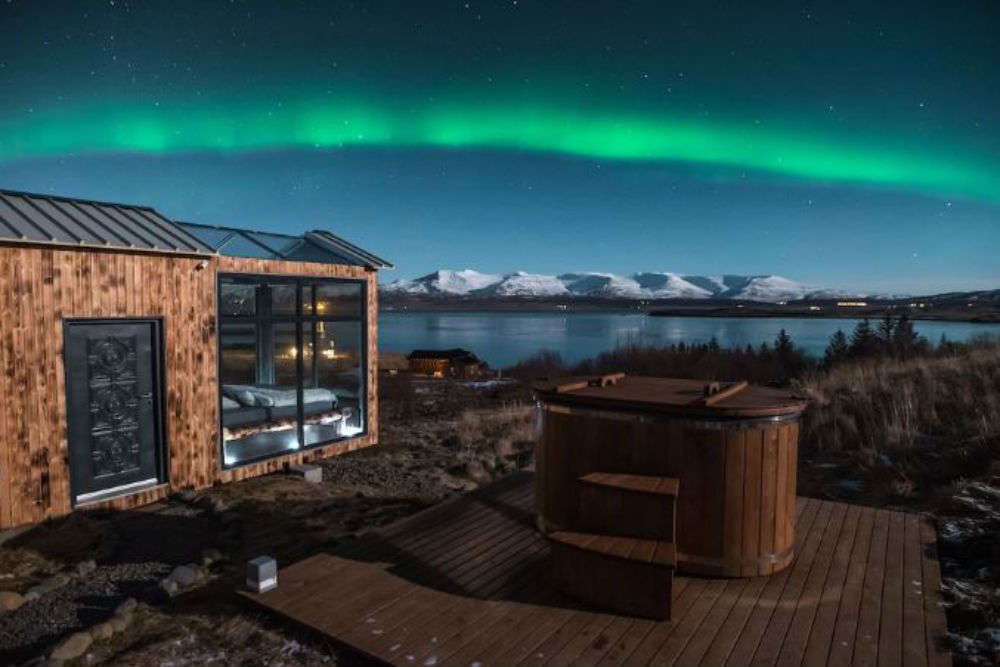 Watch the Northern Lights from your bed at this glass cabin!