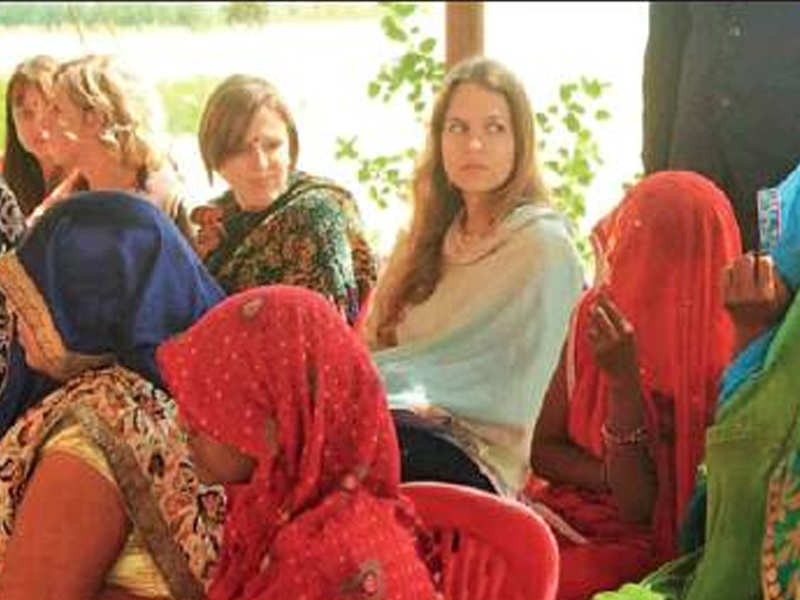 A team of students from Germany interact with villagers at Mugaliya Chhap.