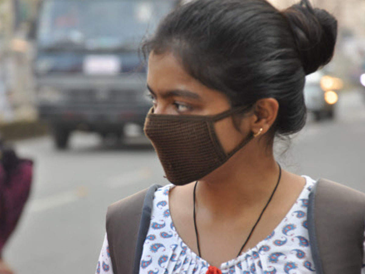 A girl protecting themselves with mask from air pollution at Fraser road in Patna on Tuesday