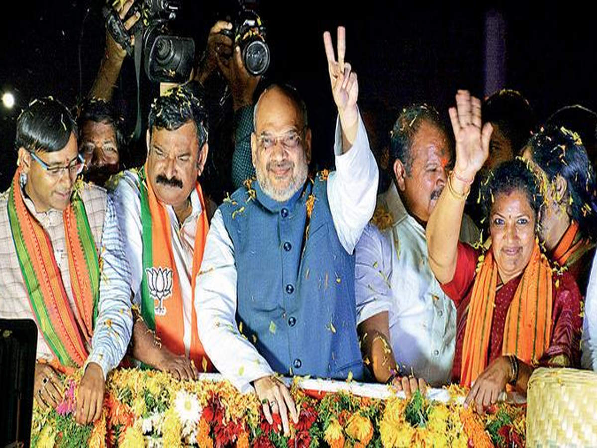 Mum’s the word? Amit Shah during the roadshow at Kancharapalem in Visakhapatnam on Thursday