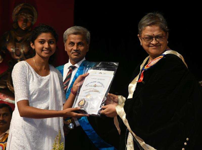 Young achiever:  Kishori Nayak, in-charge vice-chancellor, hands over a certificate to a rankholder during the convocation ceremony at Mangalore University on Friday