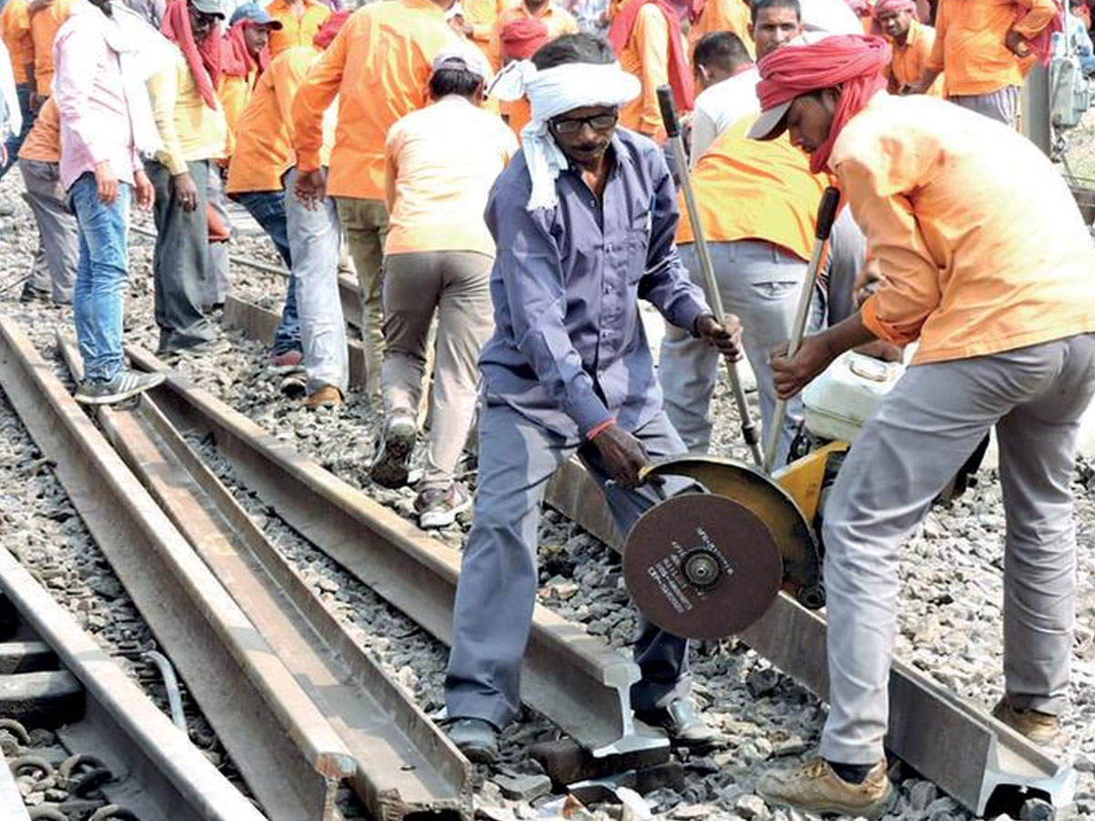 Labourers repair the railway track after the train accident on Saturday