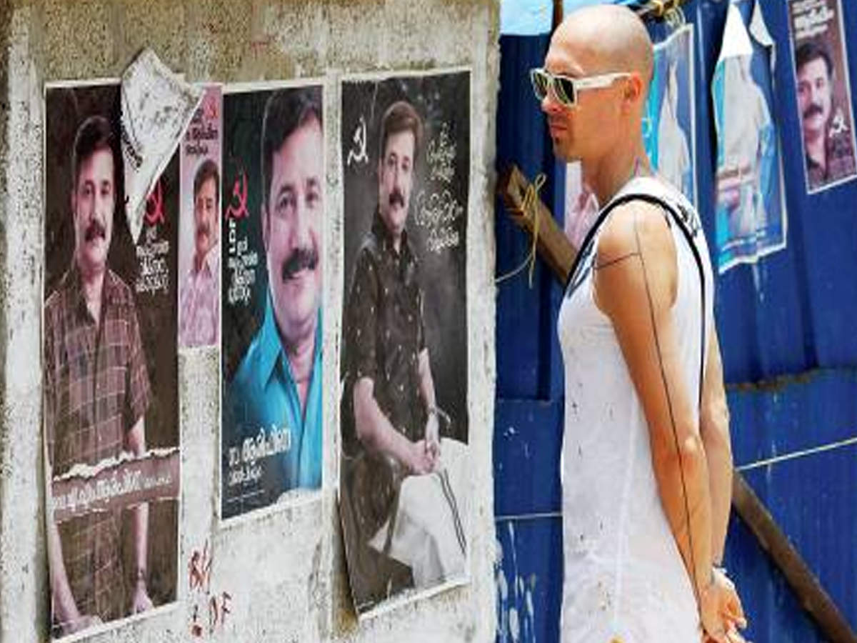 German designer Thoas Lindner looks at poll posters in Alappuzha