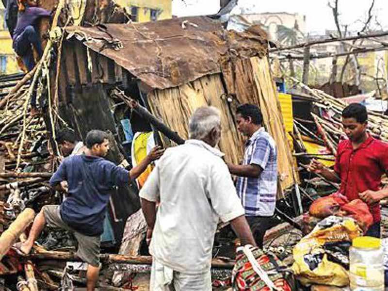 People look for their belongings in Puri on Saturday, a day after cyclone Fani hit Odisha and killed 14. (Courtesy: Bloomberg)