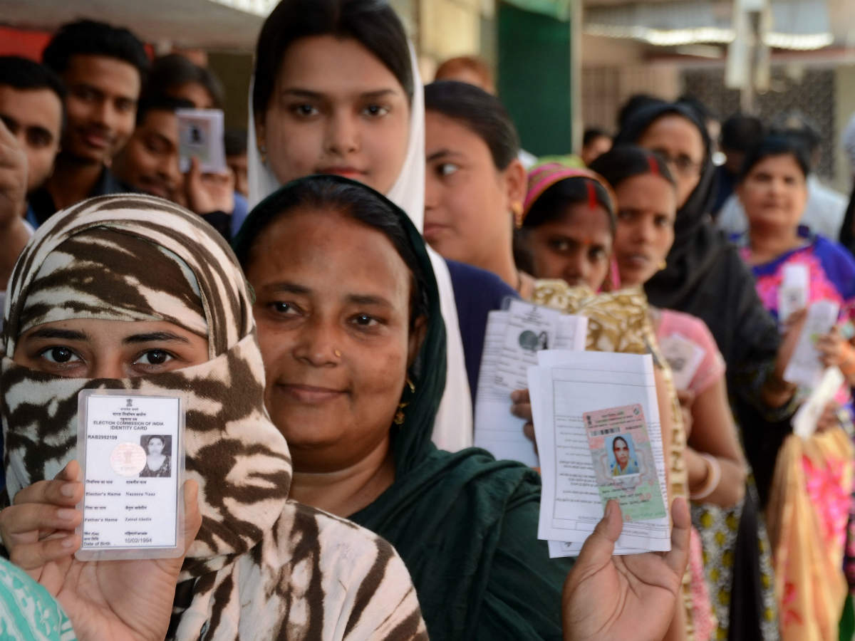 Women voters stands in a queue during cast their votes at a polling booth in Samanpura locality in Patna 
