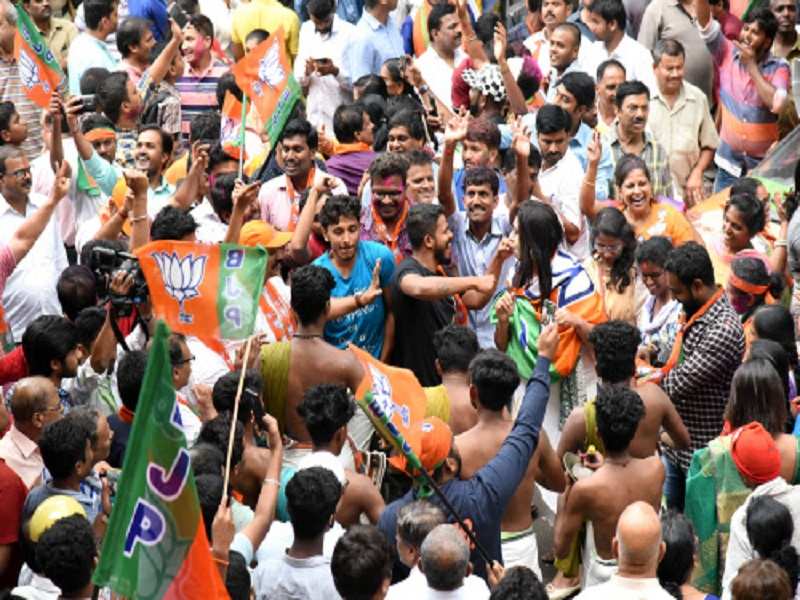 BJP supporters celebrate at state party office at Malleshwaram after BJP registered massive victoy in the loka sabha election in Bengaluru on Thursday.