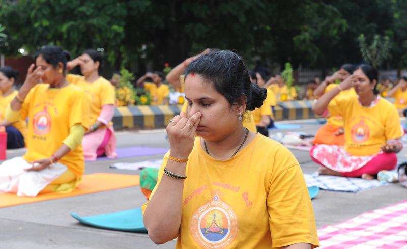 Women practise yoga on the occasion of International Yoga Day in Mangaluru on Friday