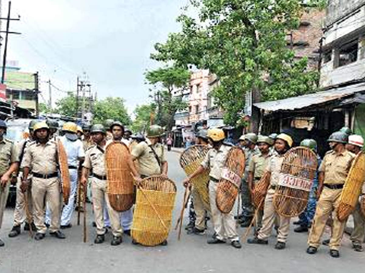 Policemen stand guard at Ghoshpara Road