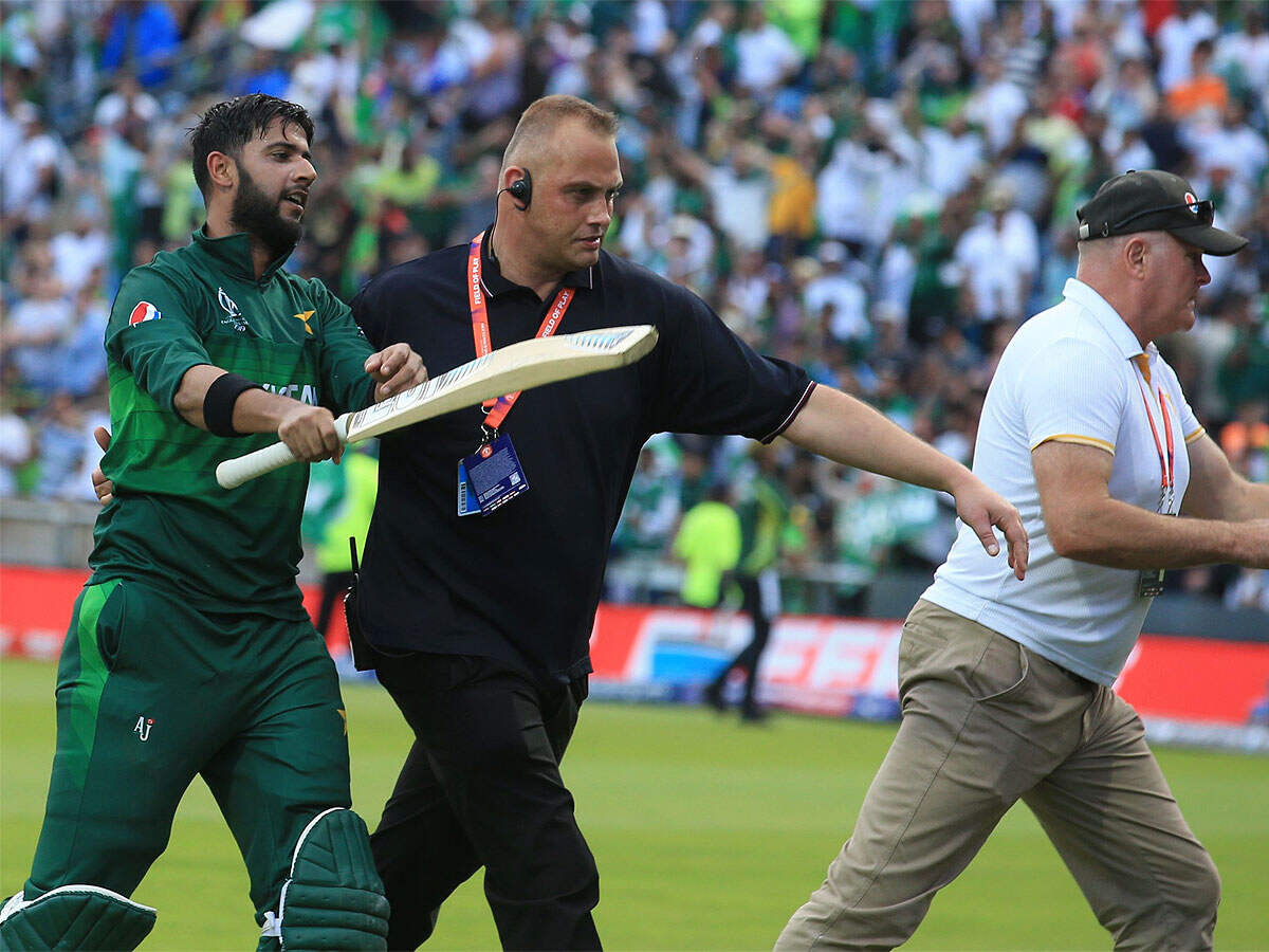Imad Wasim is escorted off the field by security officials after Pakistan beat Afghanistan at Headingley in Leeds. (AFP Photo)