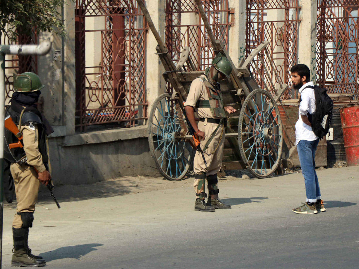 Security personnel stop people during curfew like restrictions in Srinagar. (TOI file photo: Bilal Bahadur)