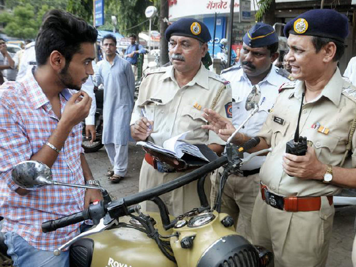 File photo of traffic police penalising a helmetless rider