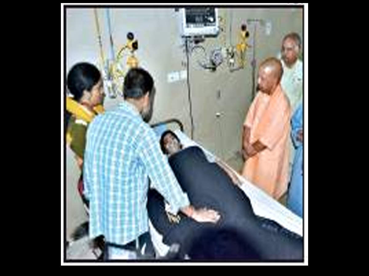 CM Yogi Adityanath meets one of the injured passengers at SGPGI in Lucknow on Wednesday