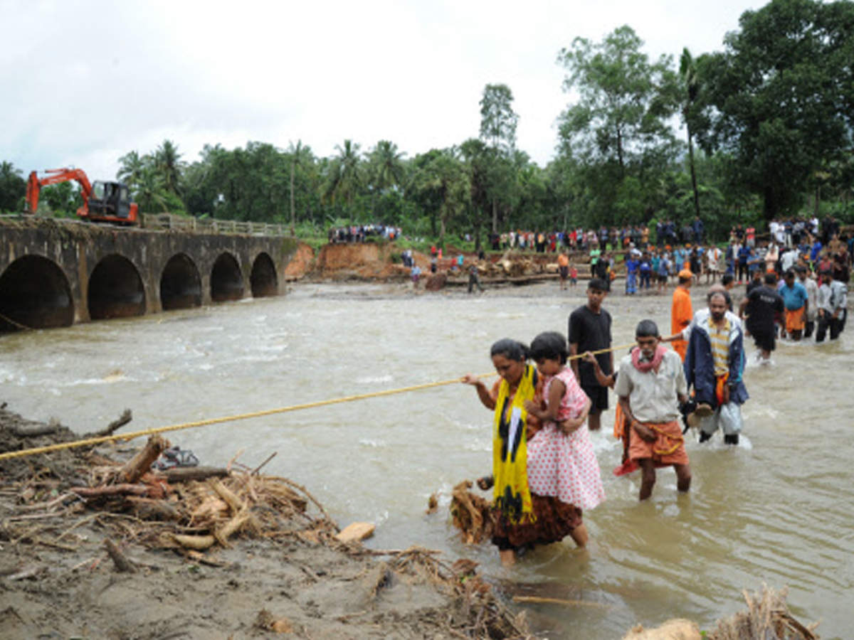 People cross ‘Yeluvare Halla Hole’ in Belthangady, Dakshina Kannada. 