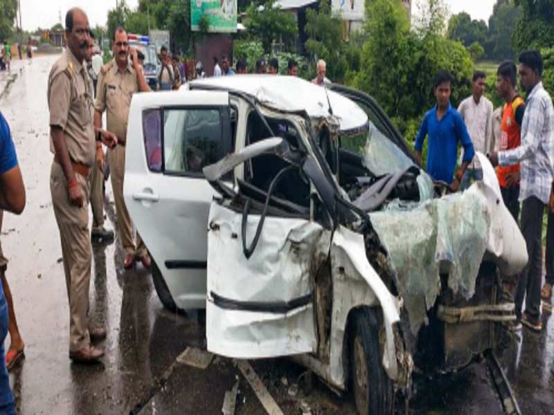  Police and people stand near the wreckage of the car in which the Unnao rape survivor was travelling during its collision with a truck near Raebareli on July 28, 2019. (Photo courtesy: PTI)