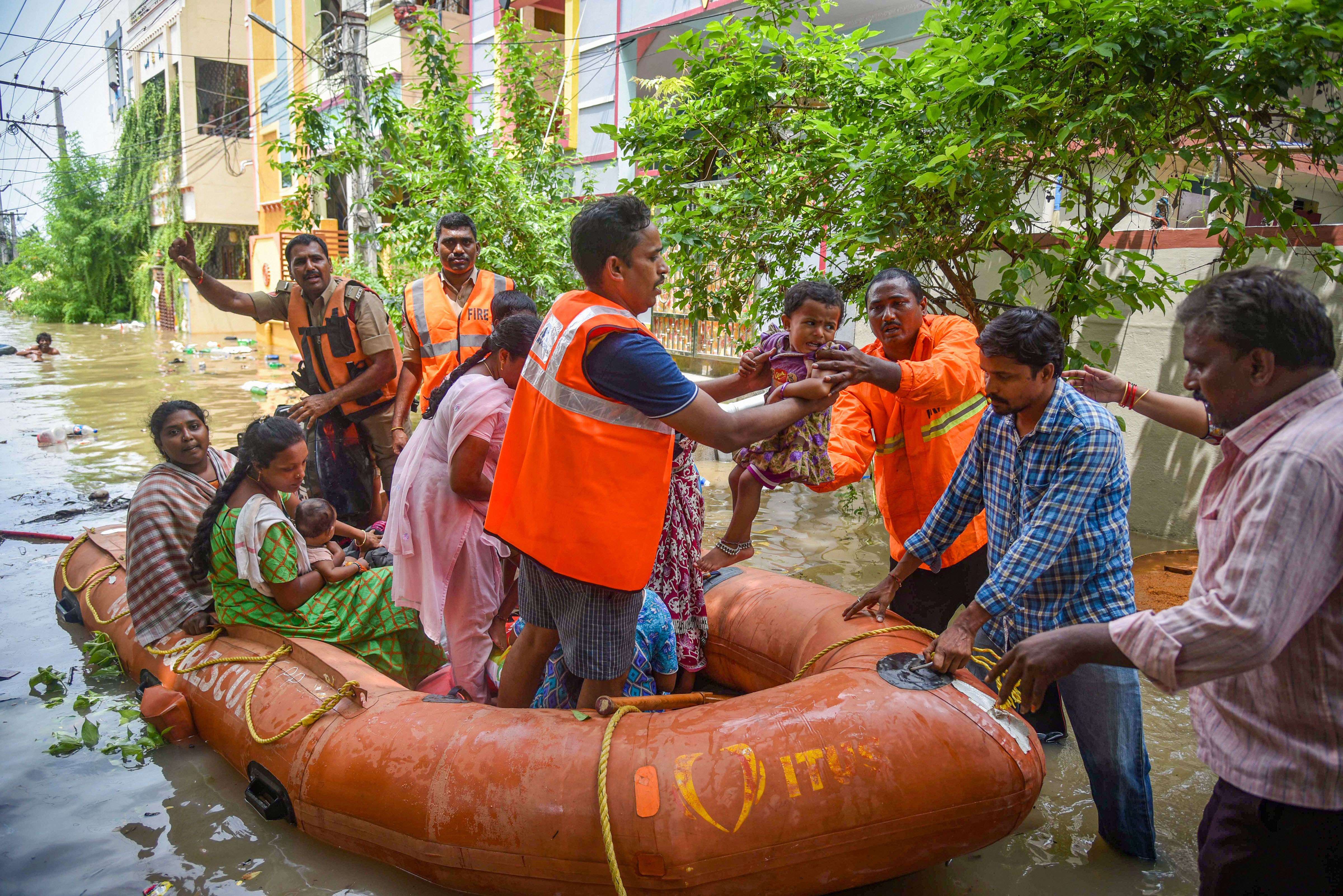 Fire department personnel rescue stranded people in flood-hit Vijayawada