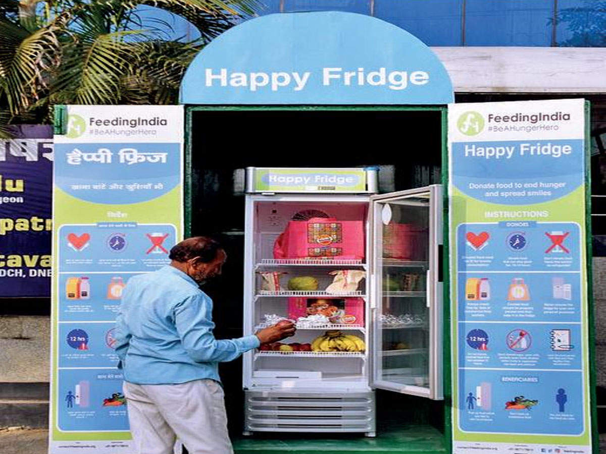 A man keeps food in the ‘Happy Fridge’ near Purania Crossing