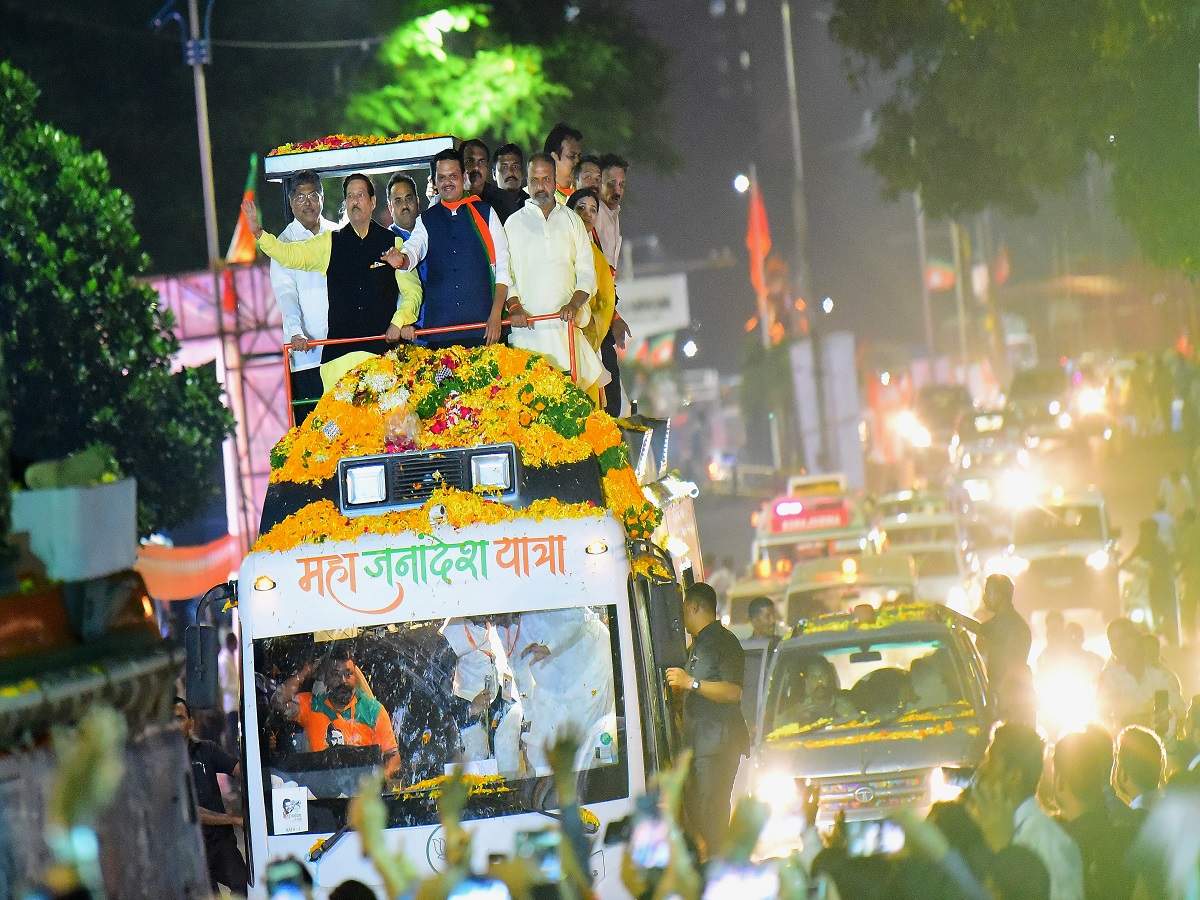 Maharashtra CM Devendra Fadnavis greets people during his Mahajanadesh Yatra in Pune