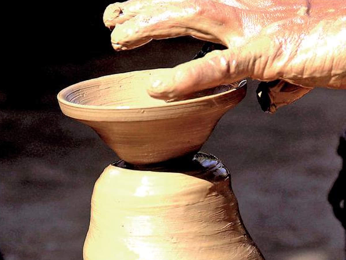 A potter makes a diya in Allahabad on Sunday