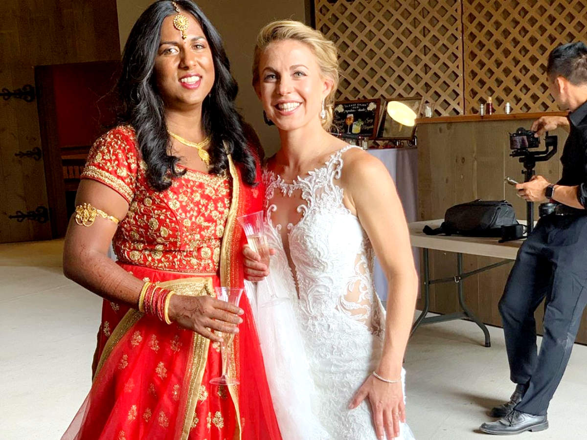 This Indo-American lesbian couple donned a red lehenga and white gown for their grand wedding