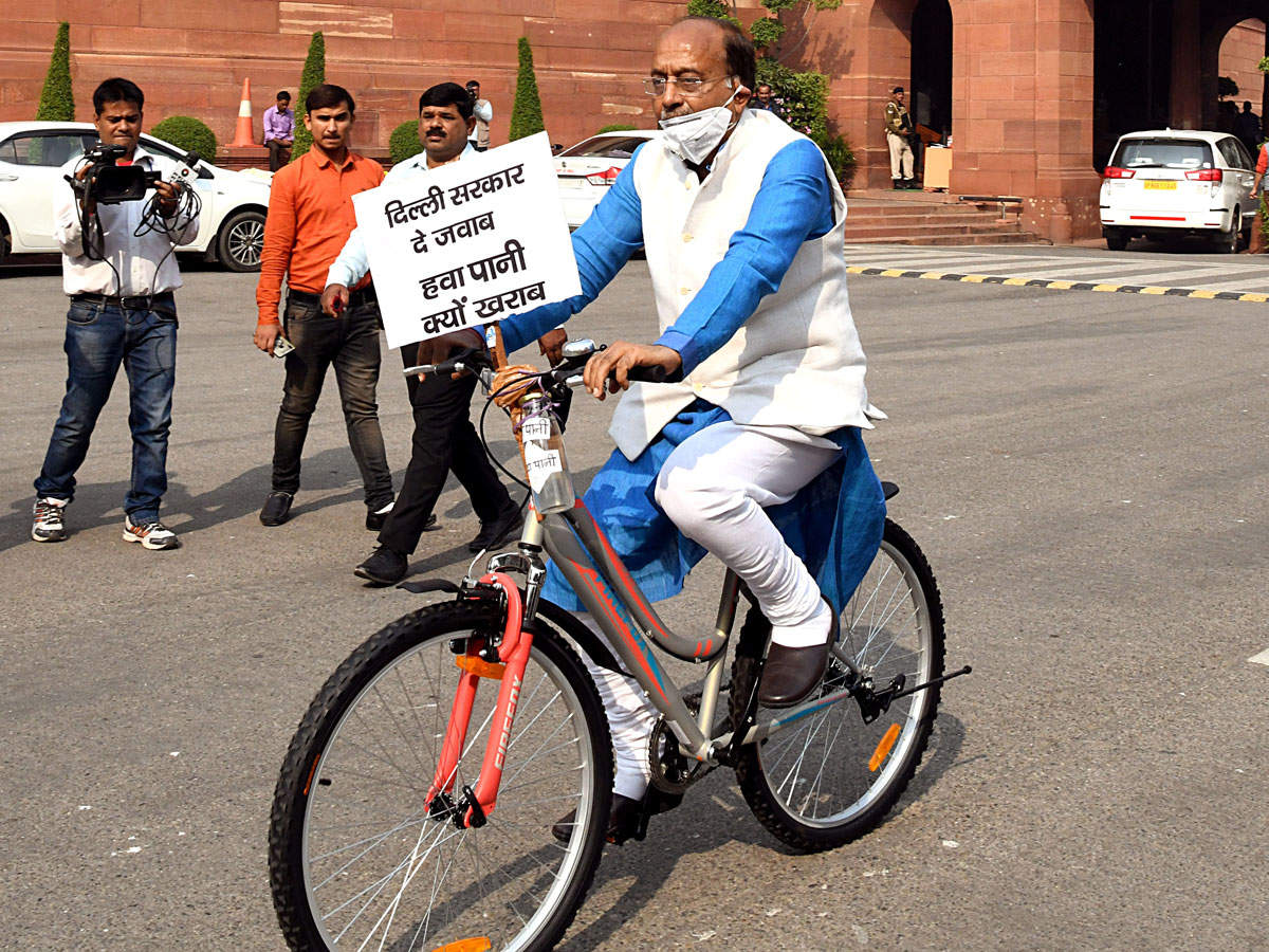 BJP MP Vijay Goel wears a face mask as he arrives at the Parliament on a bicycle during the winter session, in New Delhi. (File photo)