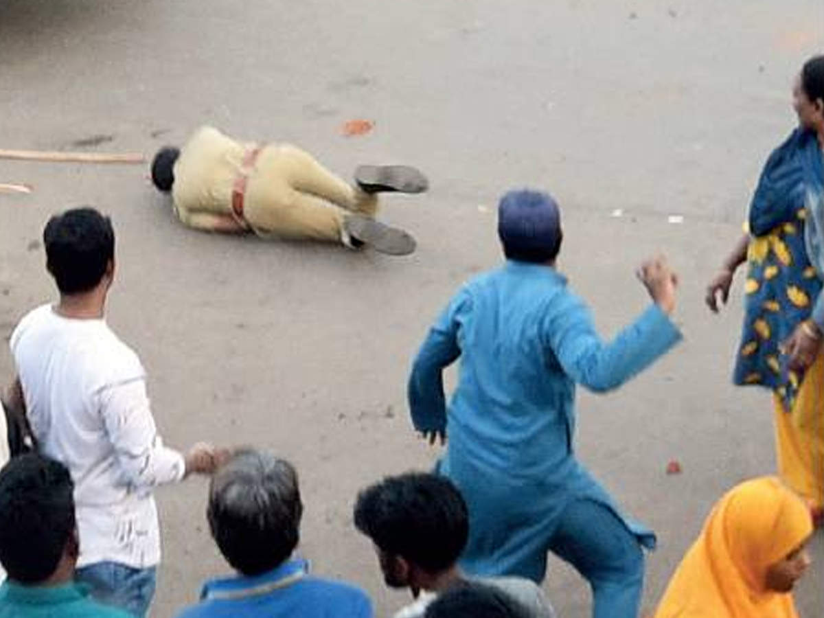 People attack a policeman in Shah-E-Alam area in Ahmedabad on Thursday.
