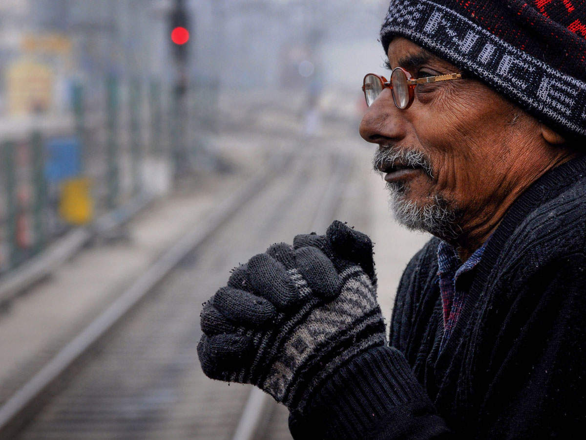 A passenger, in wollens, shivers due to coldwaves while waiting for his train at a railway station in Amritsar on Dec 27, 2019. (PTI photo)