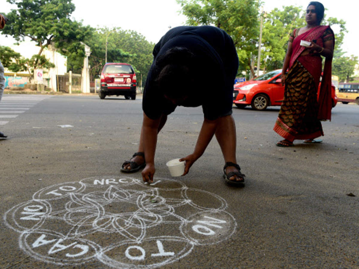 A protester draws kolam at Besant Nagar in Chennai on Sunday
