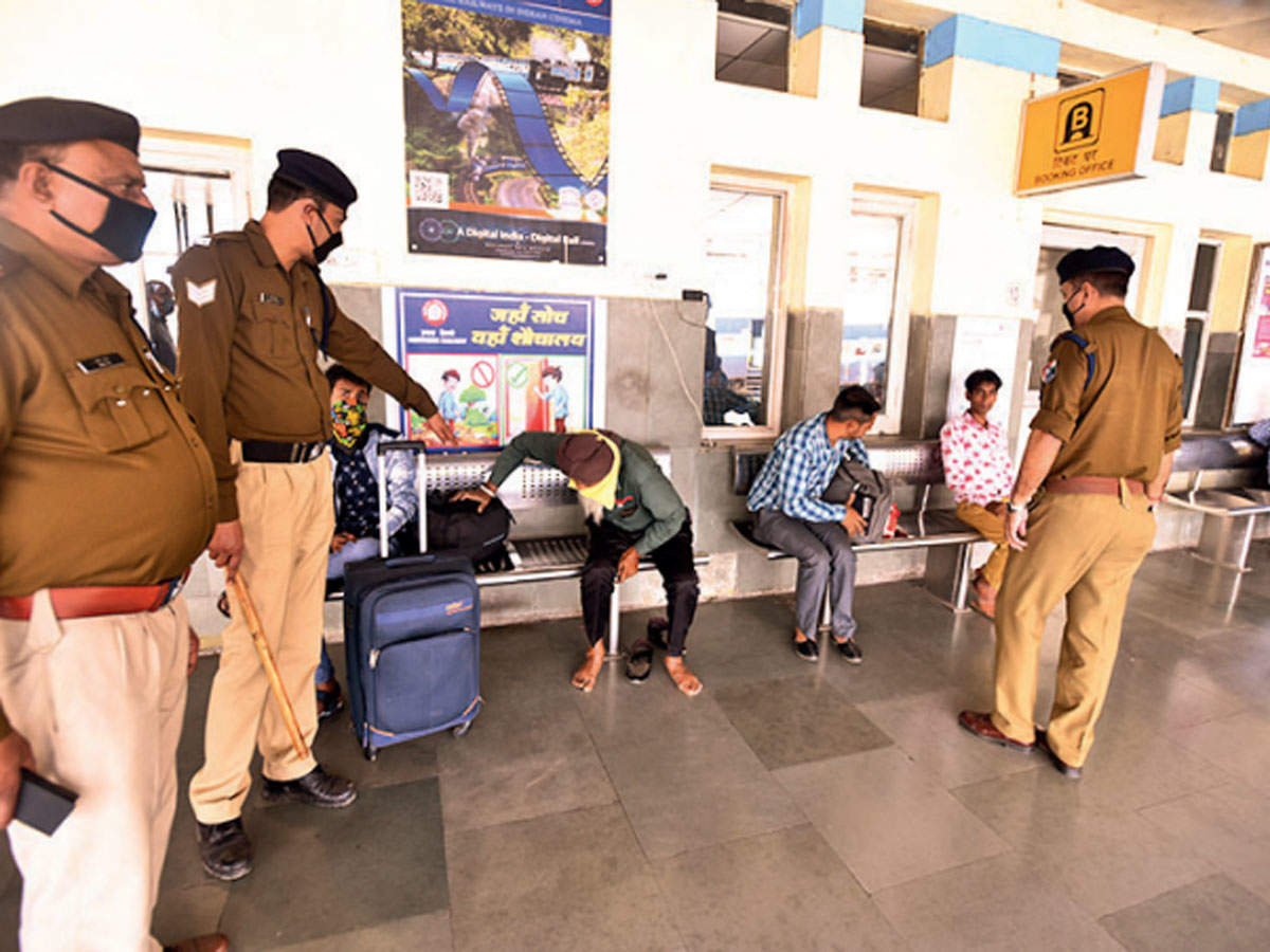 RPF personnel guiding passengers while maintaining distance from them at the Chandigarh railway station