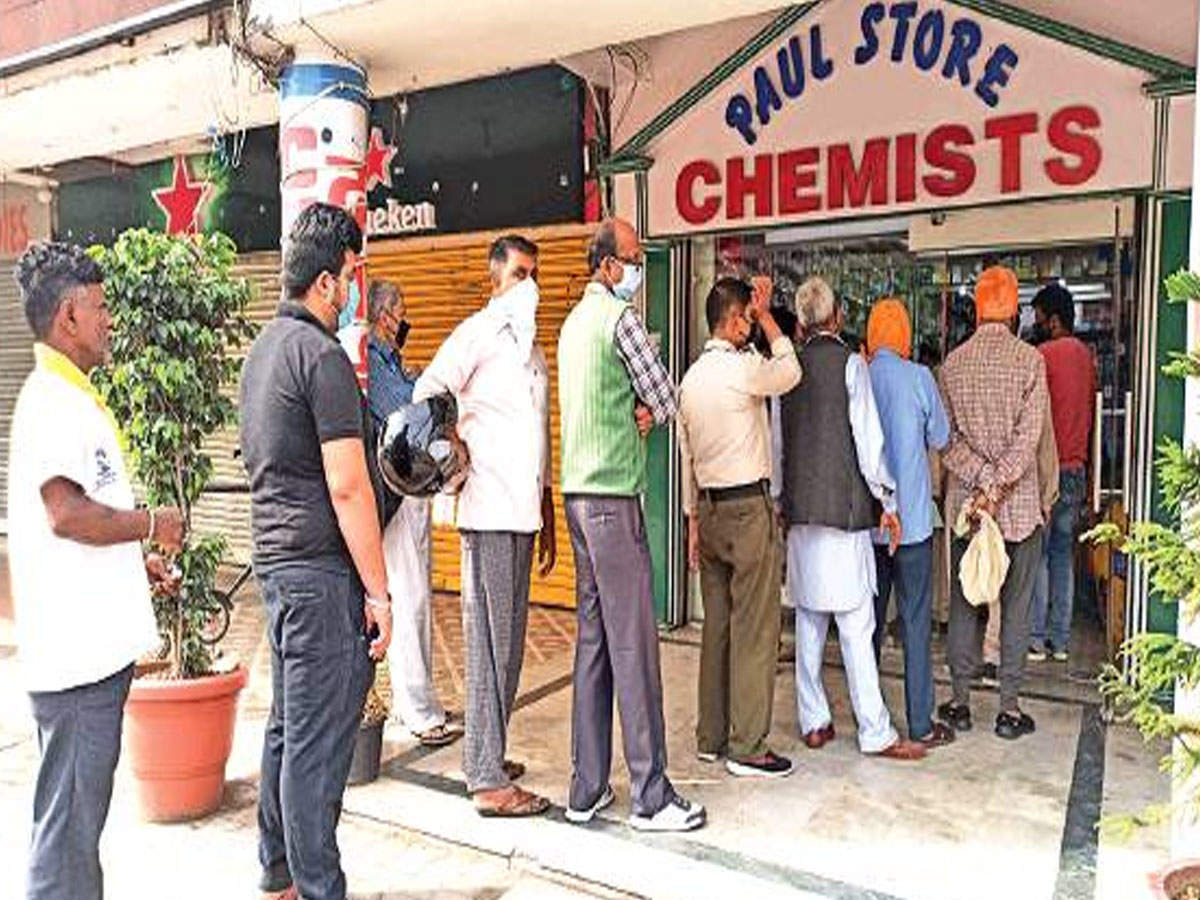 People line up to buy medicines at chemist store in Sector 22, Chandigarh, on Wednesday