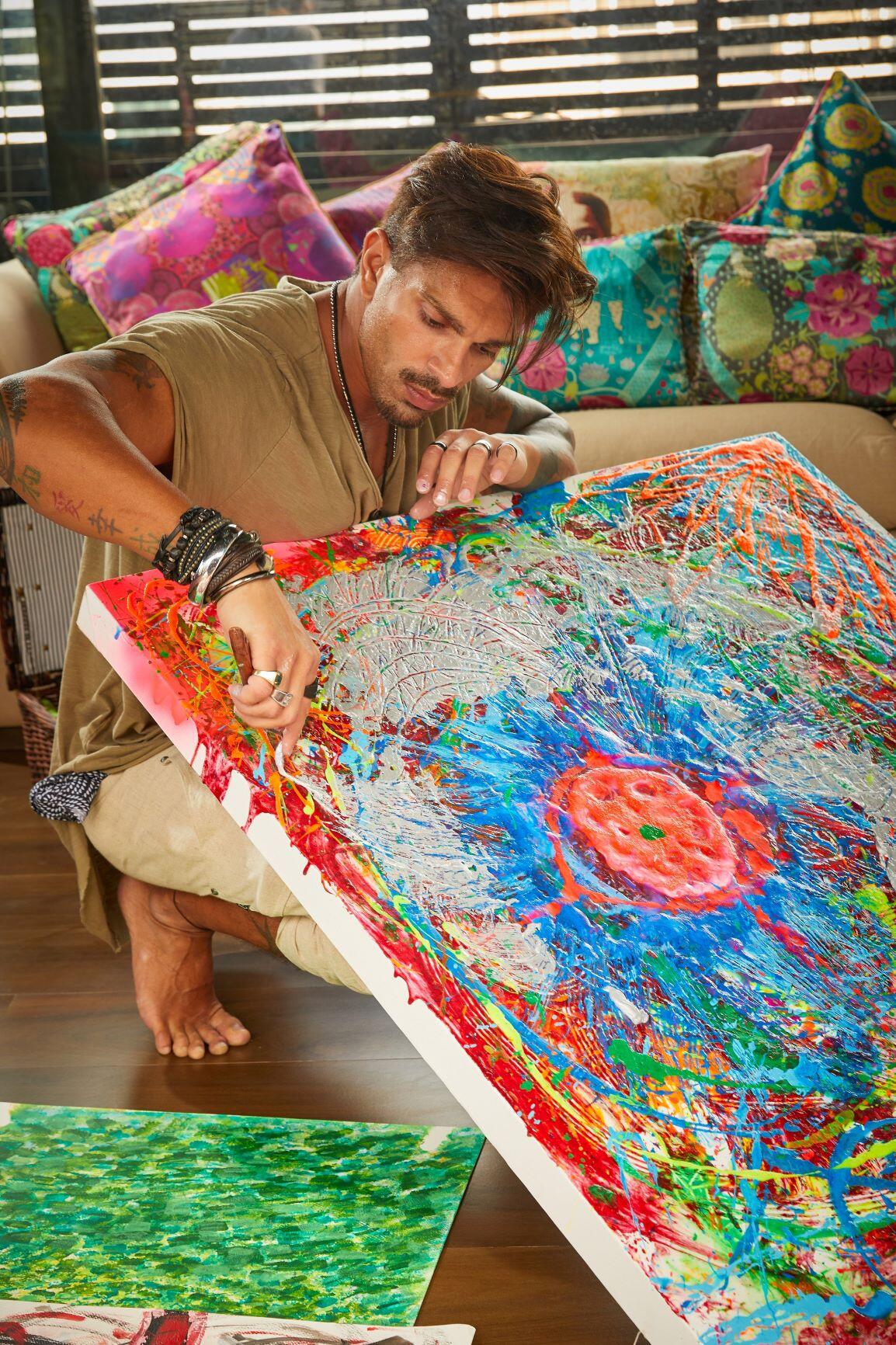 Karan Singh Grover involved in neon-drenched painting