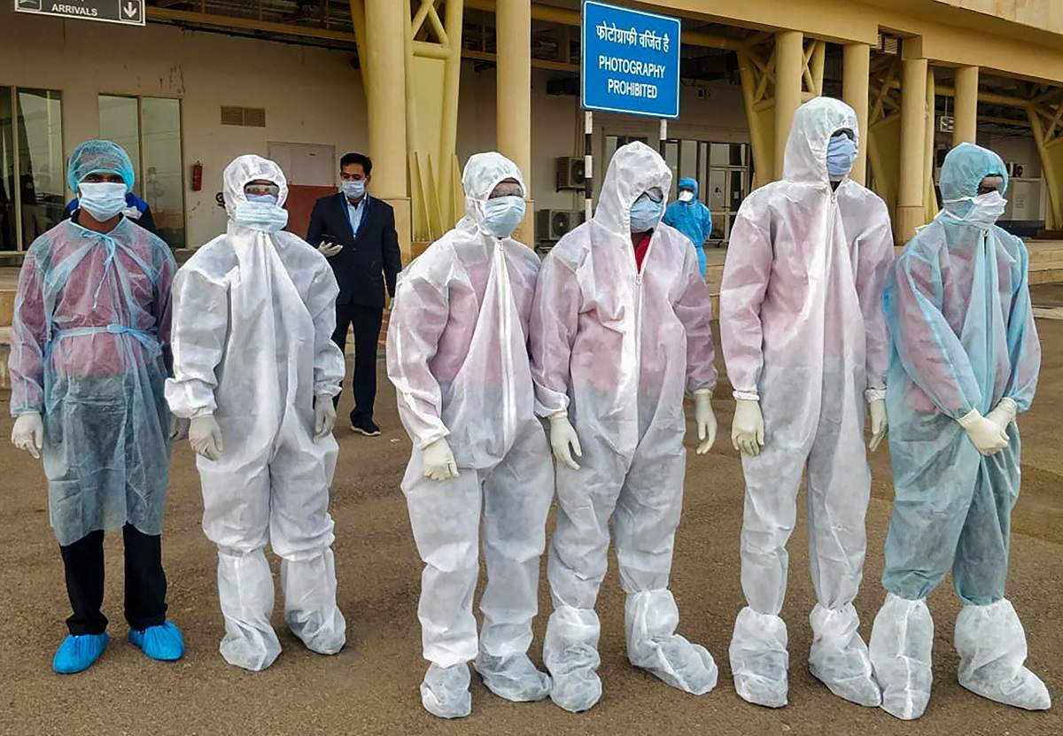 Medics wearing protective gears wait for Indian nationals evacuated from Iran to undergo a thermal screening test (PTI file photo)