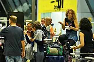German tourists stranded in Thiruvananthapuram arrive at the Trivandrum International Airport to board the special Air India flight arranged to evacuate them on Tuesday