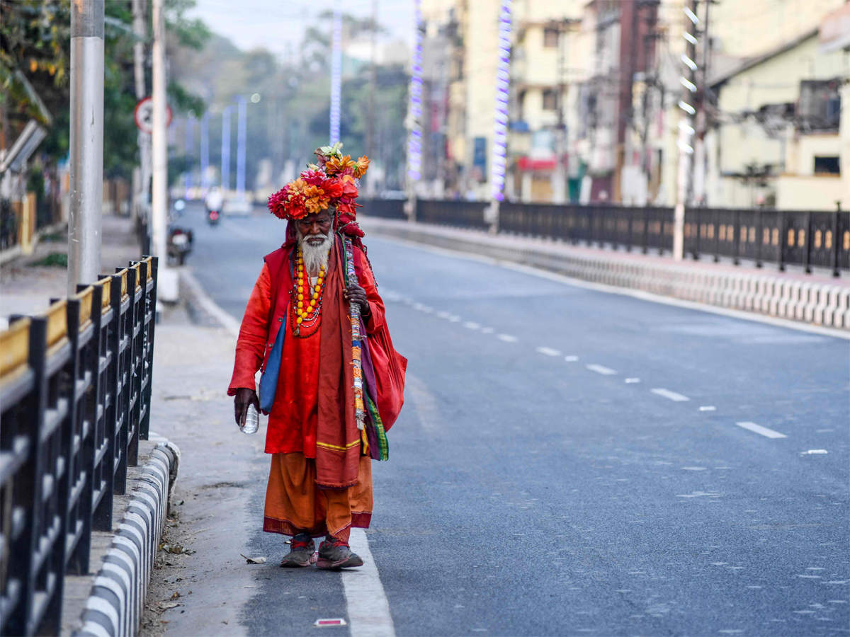 A sadhu walks on a deserted road during nationwide lockdown as a preventive measure against the COVID-19  in Guwahati on April 2, 2020. (AFP Photo)
