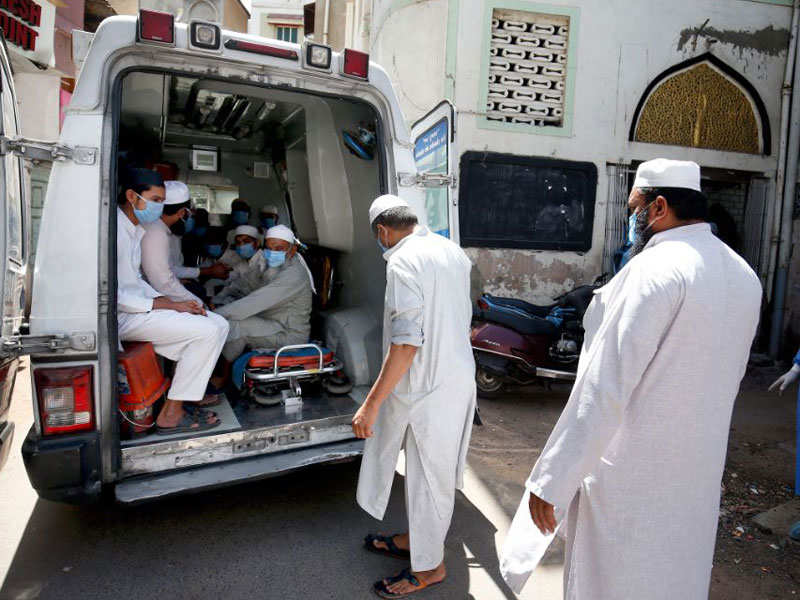 Medical workers take people who attended Tablighi Markaz of Nizamuddin in New Delhi, to the quarantine facility, in Ahmedabad on Friday. (ANI Photo)