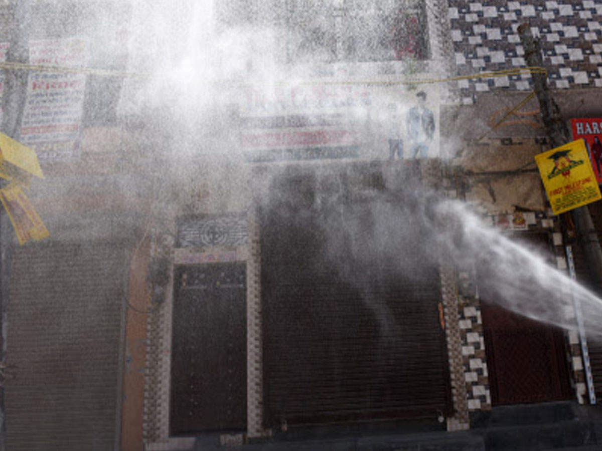 A Delhi municipal corporation staff sanitises the street at an area in Delhi amid coronavirus pandemic