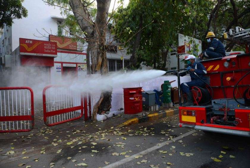 Firefighters from Ahmedabad Fire and Emergency Services spray disinfectant on city streets (AFP)