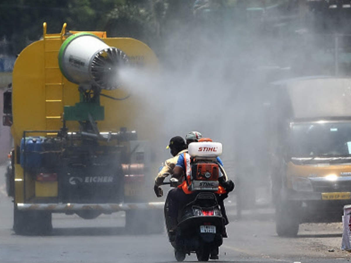 Workers sprays disinfectant at Rattan Bazaar road in Chennai