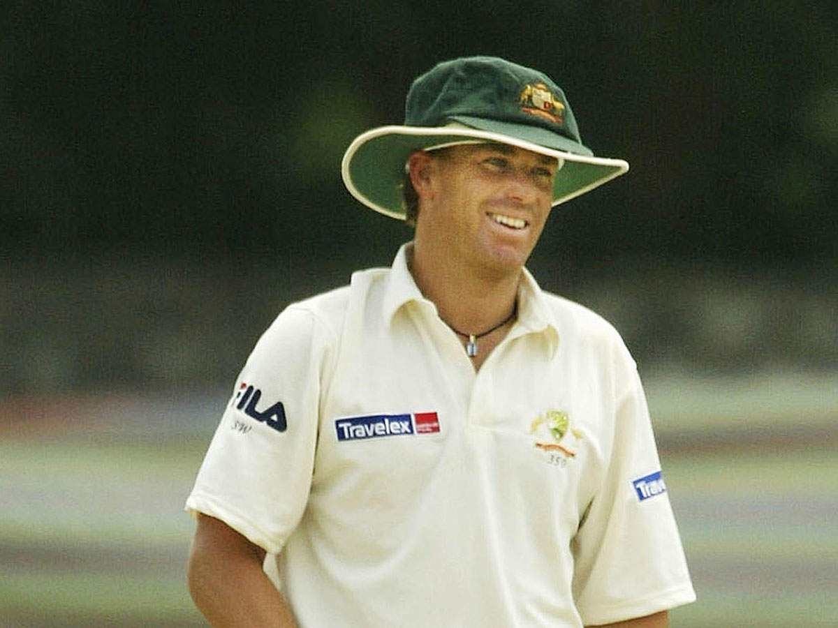 Shane Warne wearing a Baggy Green Cap as well as a floppy white hat in 2004. (Getty Images)