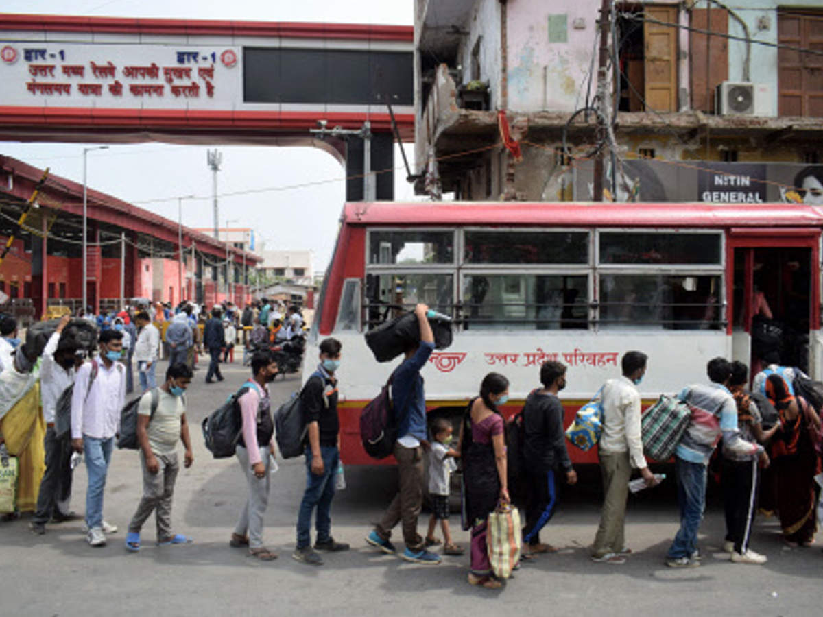 Migrants board a bus to reach their native places outside during the ongoing Covid-19 lockdown, in Prayagraj on Tuesday. (PTI photo)