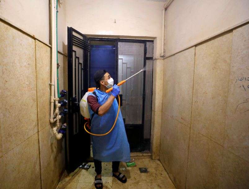 A volunteer of a medical team sprays disinfectant in a house as a precaution to contain the spread of the coronavirus disease  at Shubra El Kheima in Al Qalyubia, Egypt