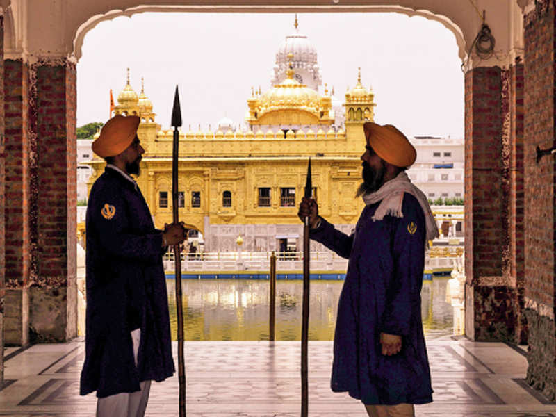 Sikh sewadars (volunteers) stand guard ahead of Operation Bluestar anniversary at the Golden Temple on Thursday