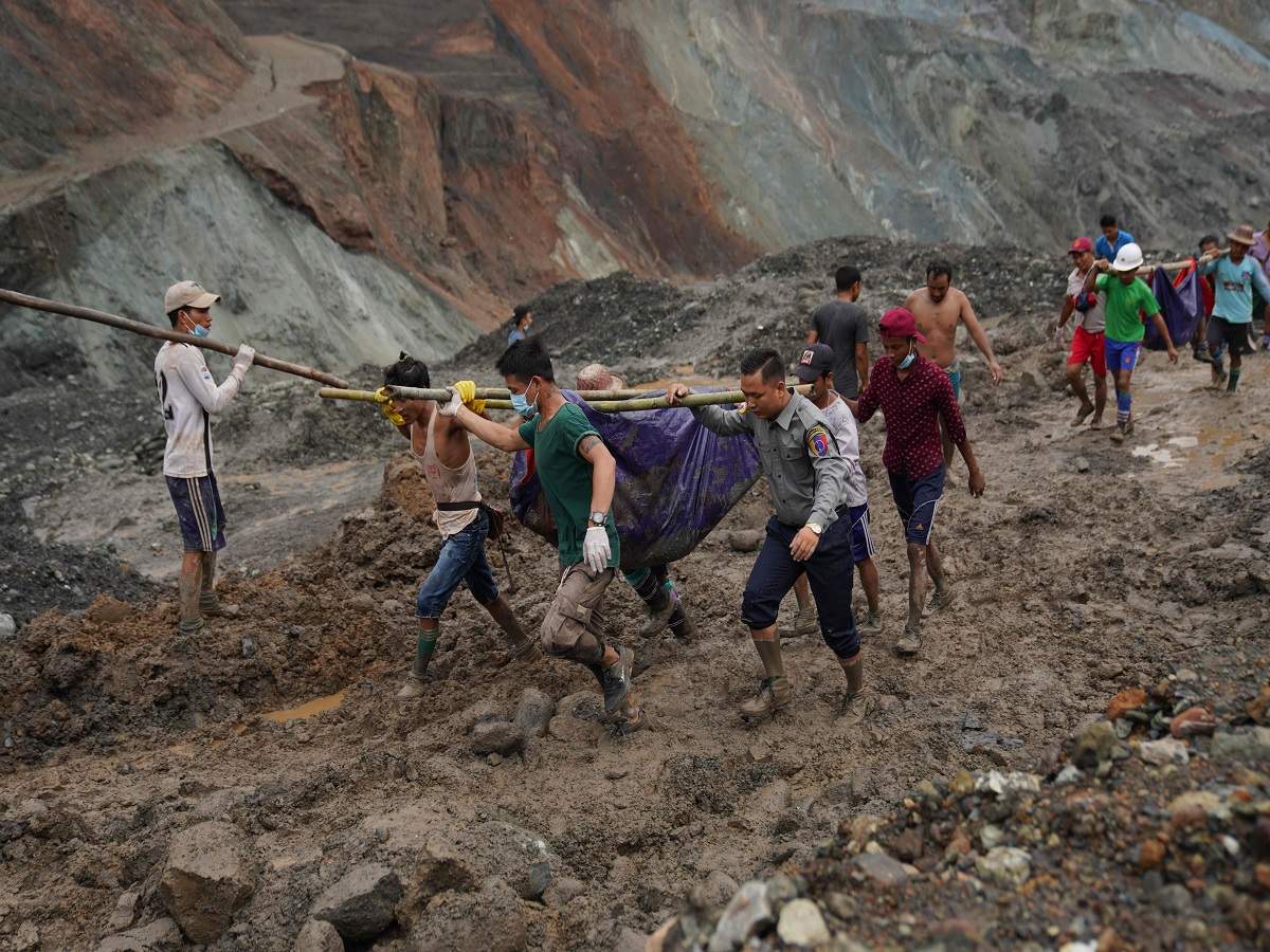 Rescuers recover bodies near the landslide area in the jade mining site in Hpakhant in Kachin state on July 2, 2020. (AFP)