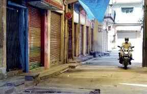 A policeman patrols deserted SP Road which remained locked down despite restrictions being lifted in Bengaluru